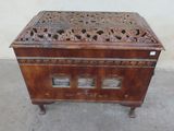 a small wooden box with carvings on top of it