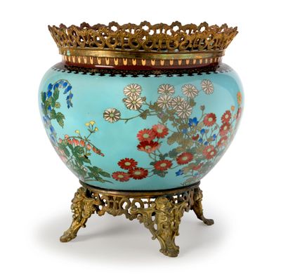a blue vase with flowers on it and a gold crown on top
