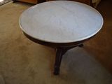 a small table with a marble top in a living room