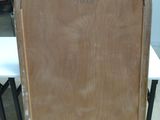 a wooden door with a sign on it in the middle of a room