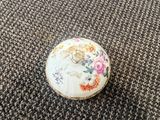 a close up of a small white plate on a carpet