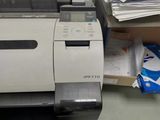 a printer that is sitting on a desk next to a pile of papers