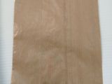 a brown paper bag on a white table