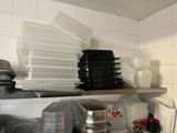 a lot of dishes and pans on the shelf in the kitchen