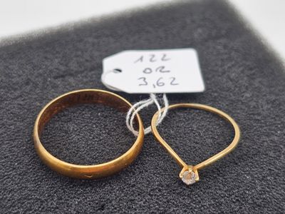 two wedding rings that are sitting next to each other