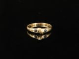 a close up of a gold ring on a black surface
