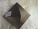 a metal object on the wall with a tag attached to it