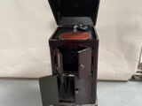 a small wooden cabinet with a stove inside of it