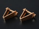 pair of wooden triangle stud earrings on a black surface