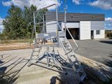 a ladder that is sitting in front of a building