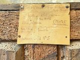 a sign on the side of a wooden wall