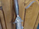 a wooden door with a metal handle and a knife on it