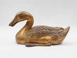 brass duck figurine on a white background