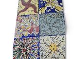 several different colored tiles with designs on them on a white surface