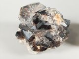 smoky crystal cluster on a white surface with a white background
