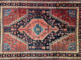 a close up of an oriental rug with a red and blue design
