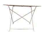 an old iron table with a wooden top and metal legs
