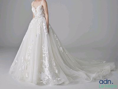 a photo of a woman in a wedding dress posing for a picture