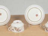 three plates and two cups on a table