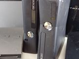 two video game consoles sitting next to each other on a table