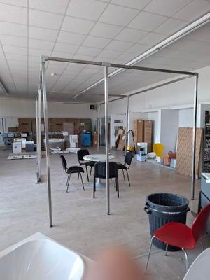 une pièce équipée de tables, de chaises et d'une télévision