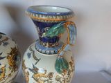 two vases that are sitting on a table