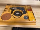 the box is open on the table with the tools in it