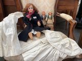 a doll that is sitting on a chair next to a doll