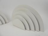 two pieces of white plastic are stacked on top of each other