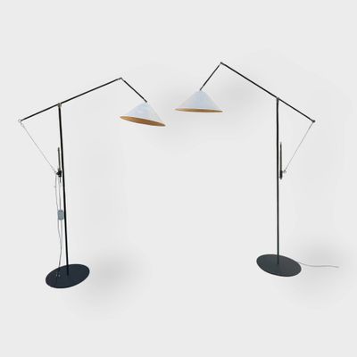 a pair of floor lamps with a white shade and a black base