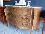 a dresser with a clock on top of it in a room