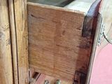 a wooden dresser with a drawer on top of it