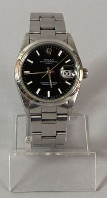 a watch that is sitting on a clear stand