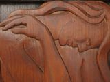 carvings of a woman ' s face on a wooden panel