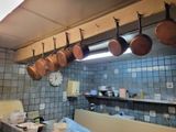 pots and pans hanging from the ceiling in a kitchen