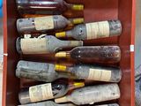 many bottles of wine in a red box on the ground