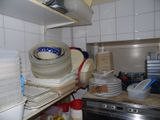 a kitchen with a lot of dishes and dishes on the shelves