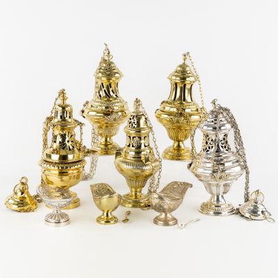 a lot of silver and gold items on a white surface