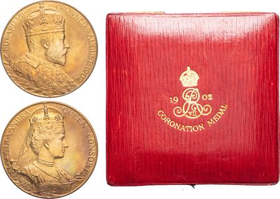 three gold sovereigns in a red box with a red cover