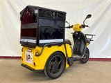 yellow and black scooter with a box on the back of it