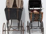 two old fashioned baby carriages sitting next to each other