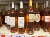several bottles of wine are on a shelf in a store