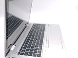a silver laptop computer sitting on a white surface