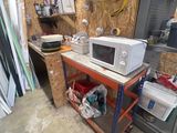une photo d'une cuisine avec un micro-ondes posé sur une étagère
