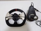 a steering wheel and a remote control on a table