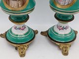 pair of green and gold vases with figures on them