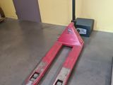 a fork lifter sitting on the floor next to a window