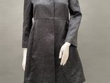 an image of a mannequin dressed in a gray dress and black tights