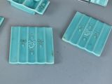 four pieces of blue glass that are on a table