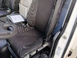 steering wheel of a truck with a seat and seat covers on it